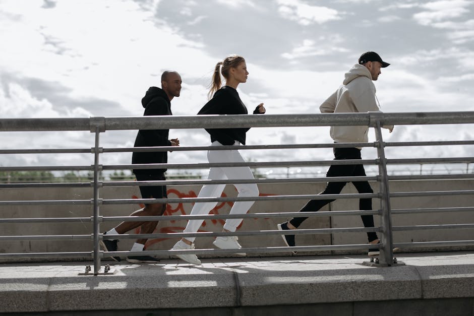 Three people jogging on a bridge, representing a healthy lifestyle outdoors.