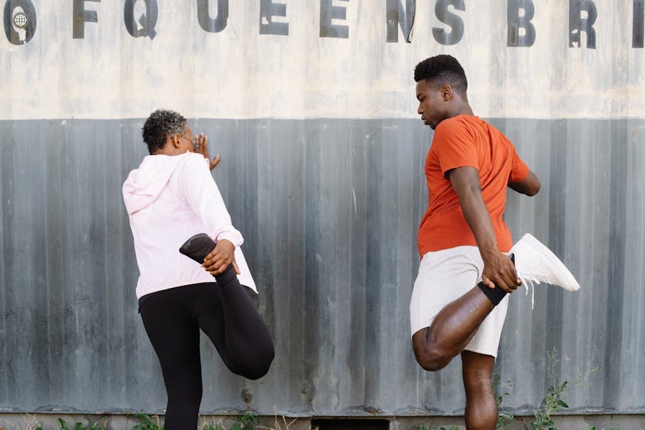 Two adults stretching outdoors with 'Queens Bridge' sign in background